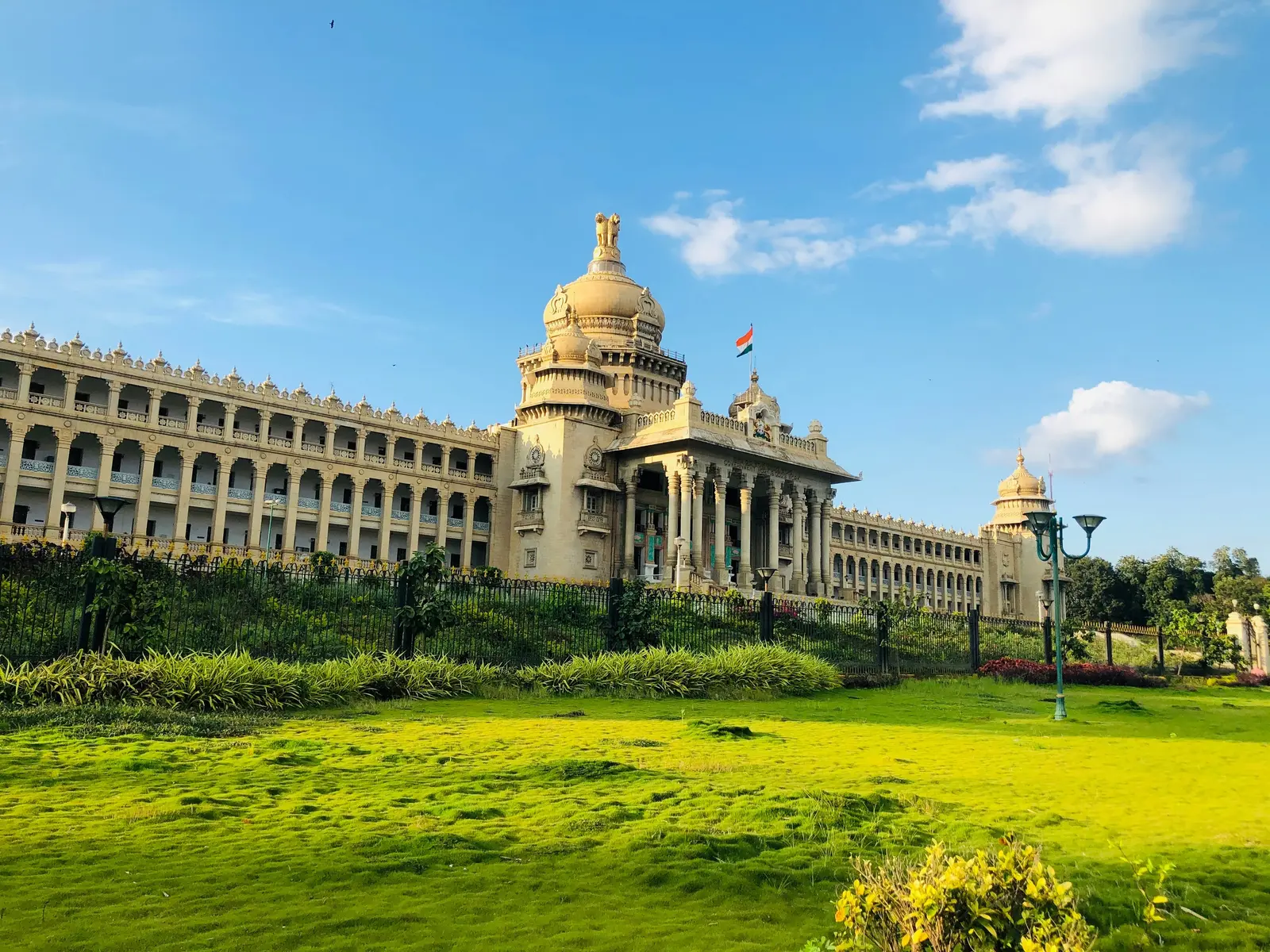 Vidhana Soudha and its lawns under a clear sky in Bengaluru, India